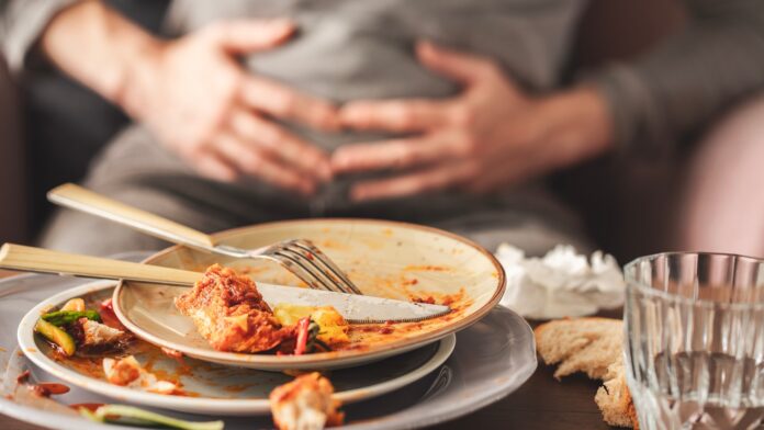 Woman,With,Bloating,And,Stomach,Pain,After,Eating